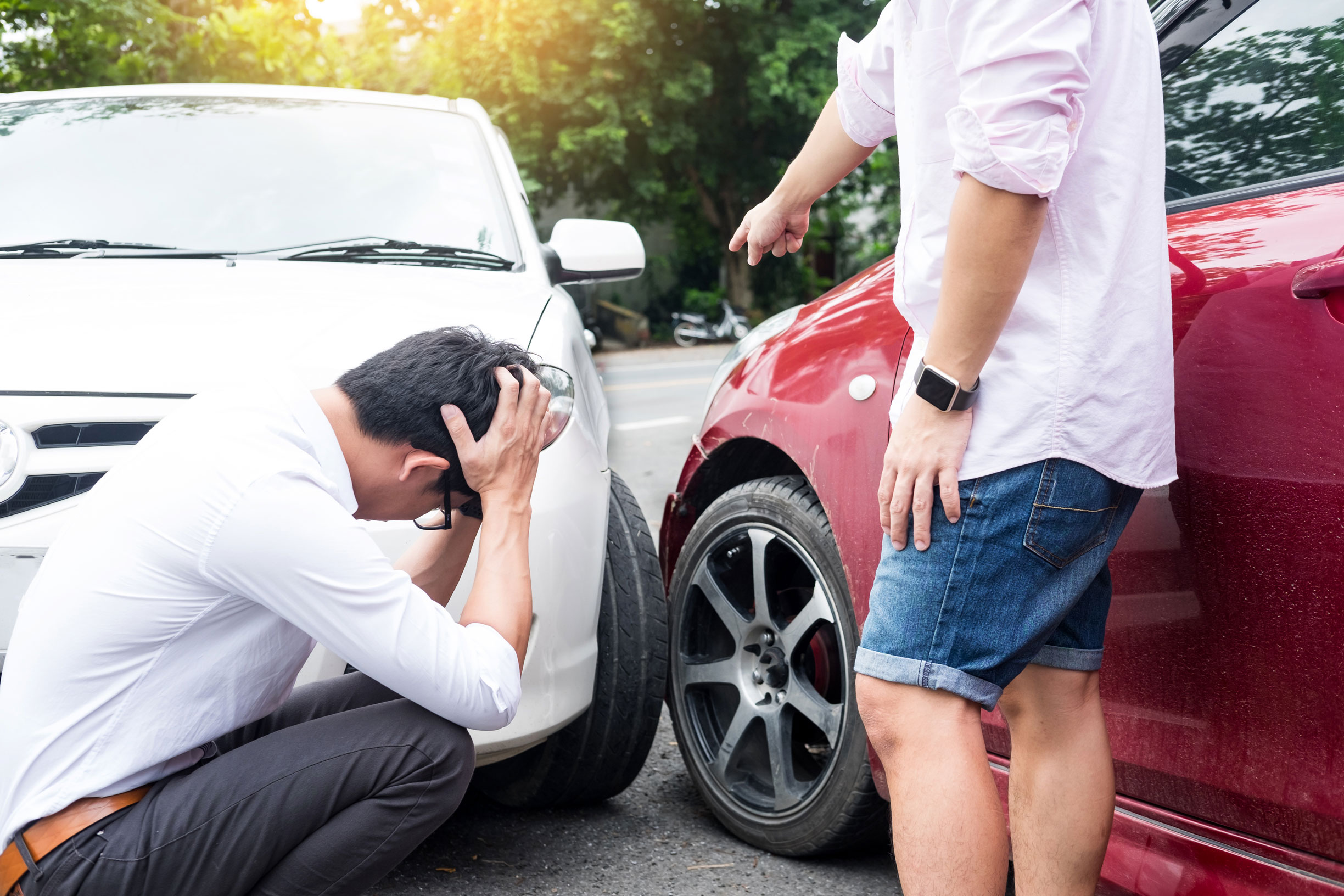Two men arguing after a car accident Traffic Collision on the ro