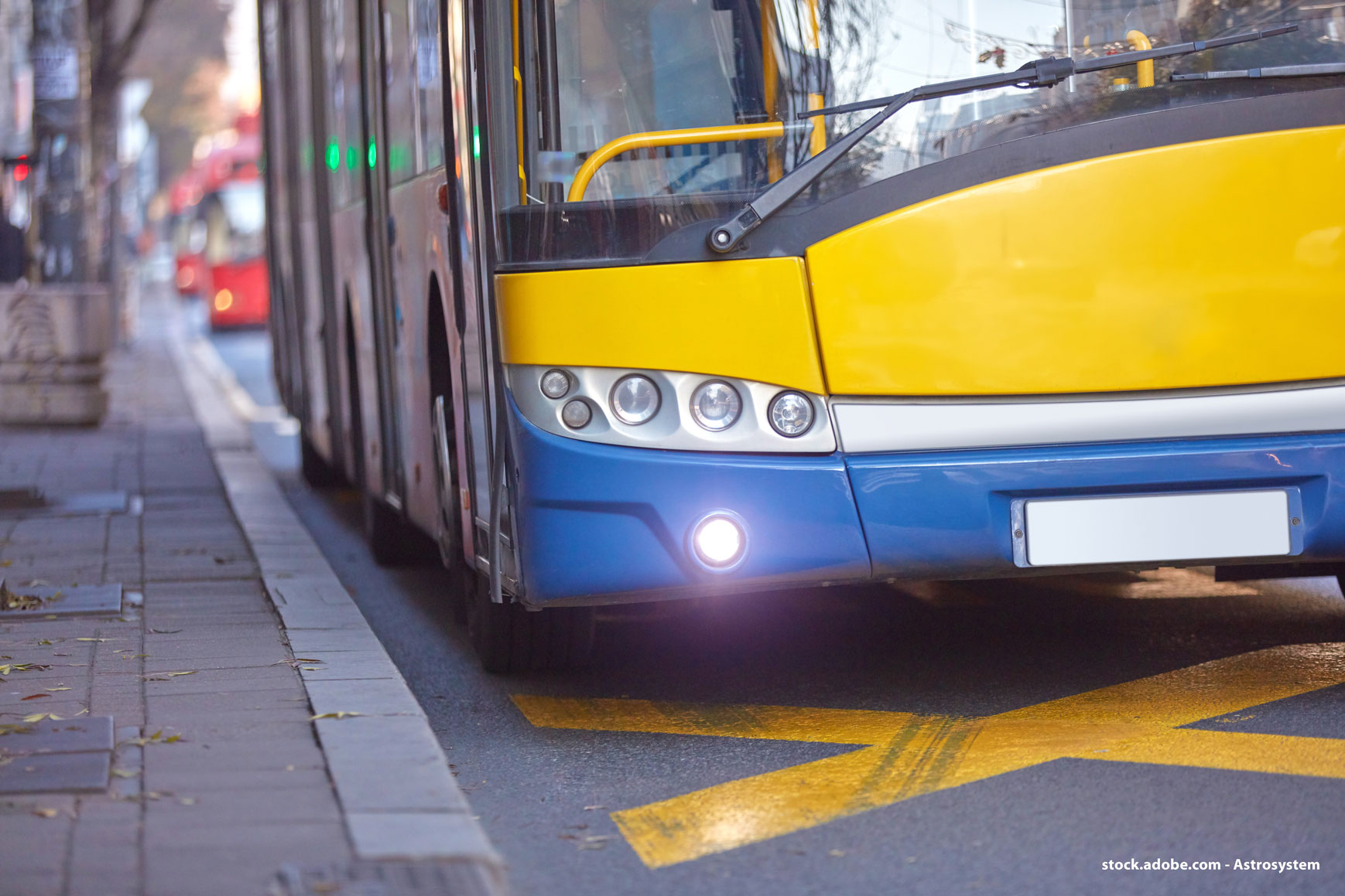 A city bus parks at the kerb