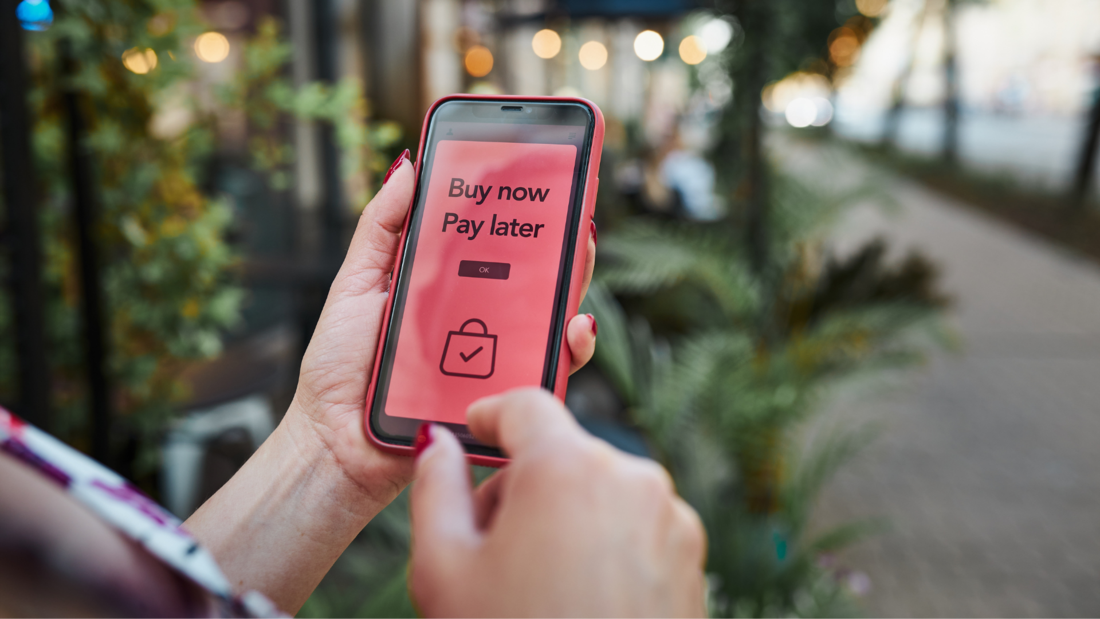 A person holding a phone displaying on its screen 