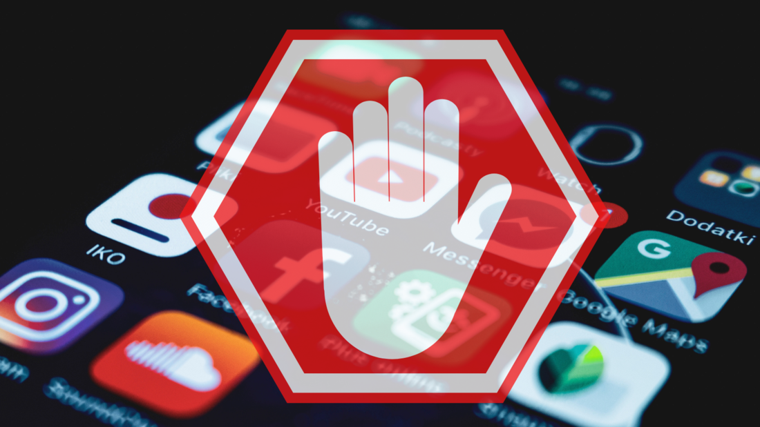 A red stop sign with a white hand on the background of a phone's screen